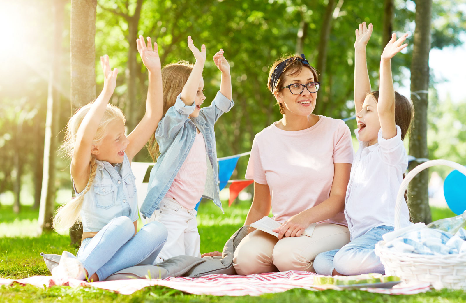 woman with kids sitting on the grass