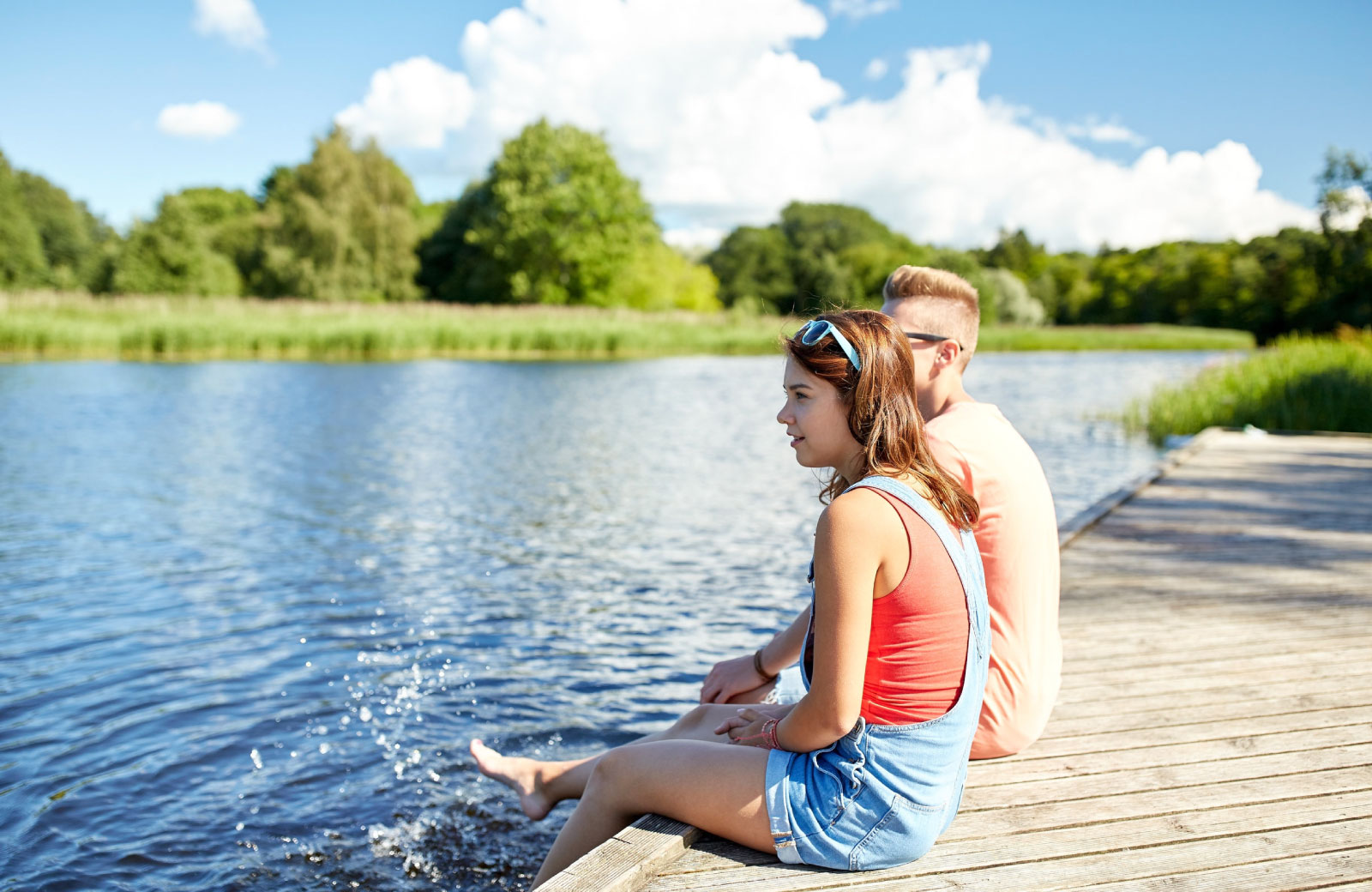 teenagers dipping their toes on the lake