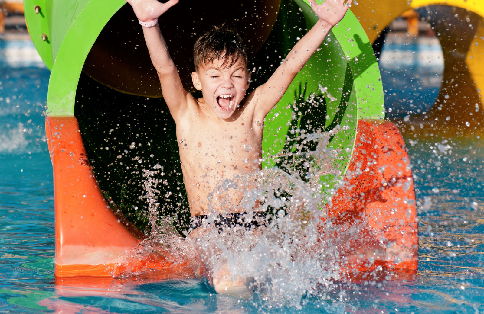 little boy enjoying in a water theme park