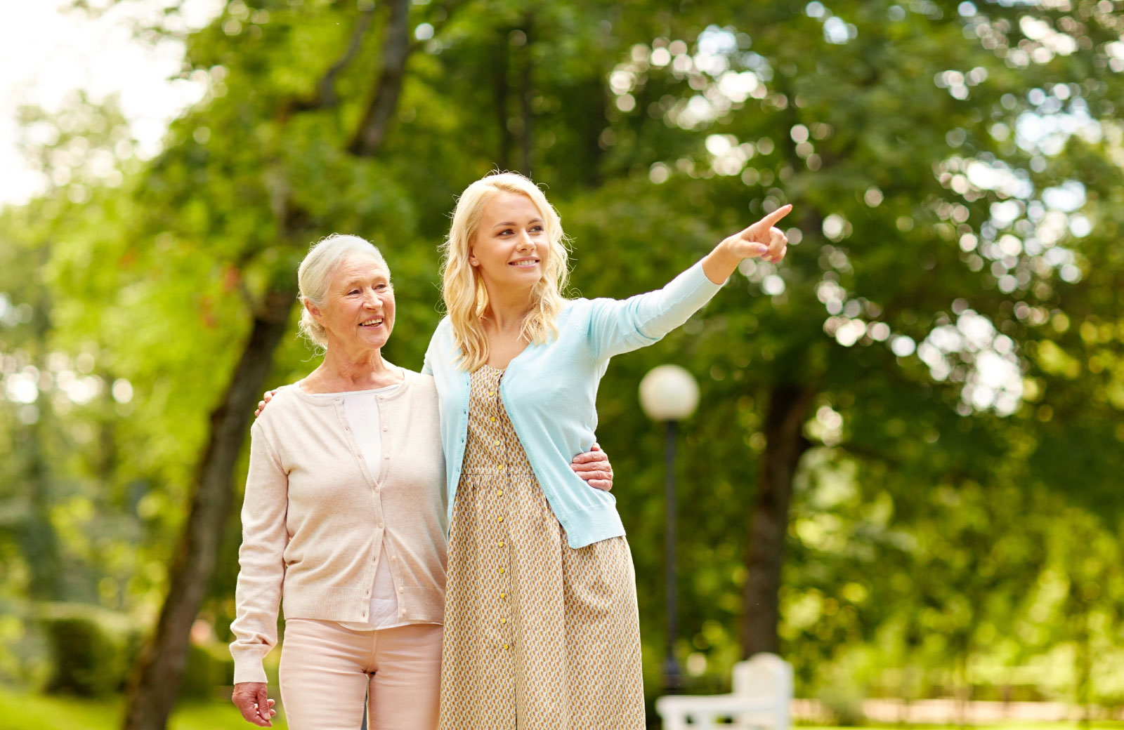 a senior woman and a young woman exploring a park