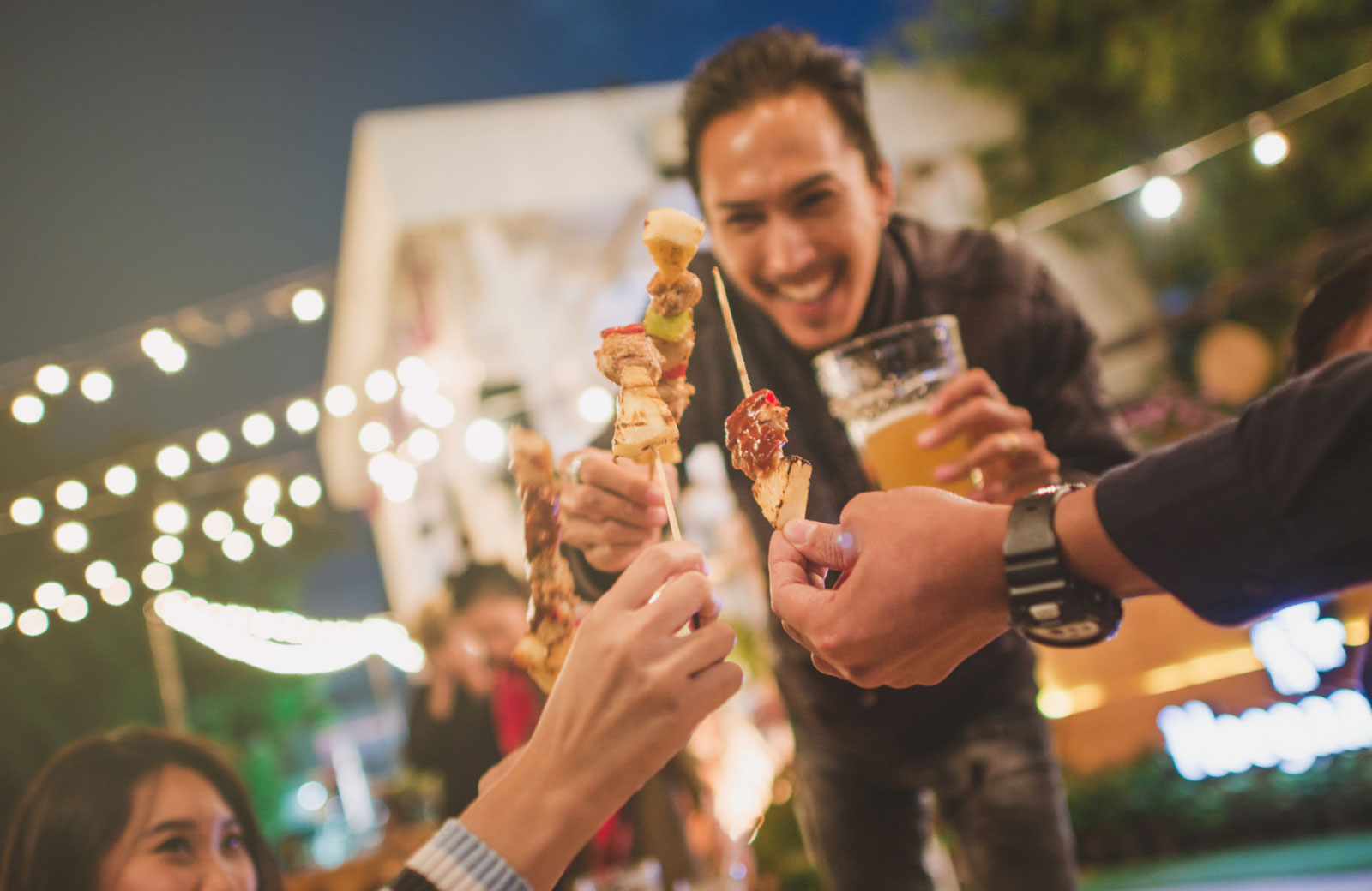 group of friends celebrating with food and beers