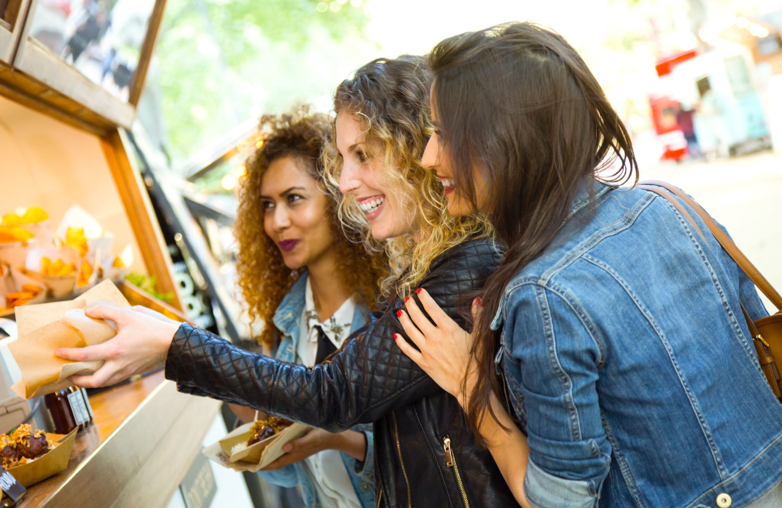 group of women buying food from food trucks