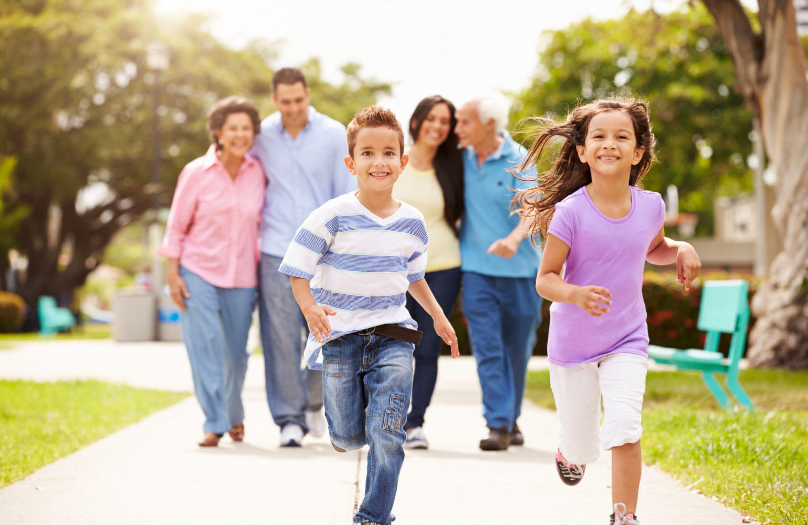 children running happily with family in background