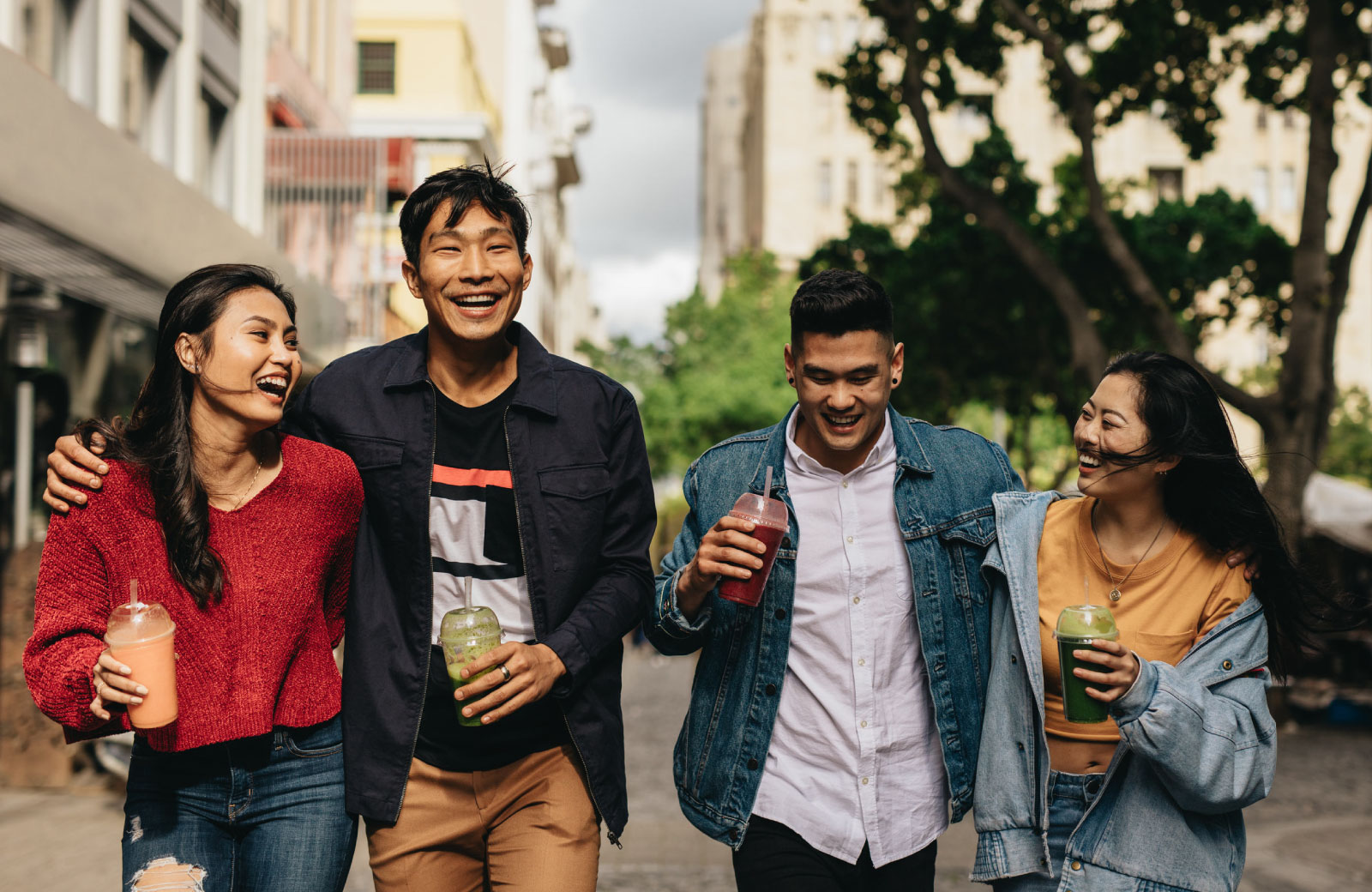 group of young Asians strolling with drinks in hand