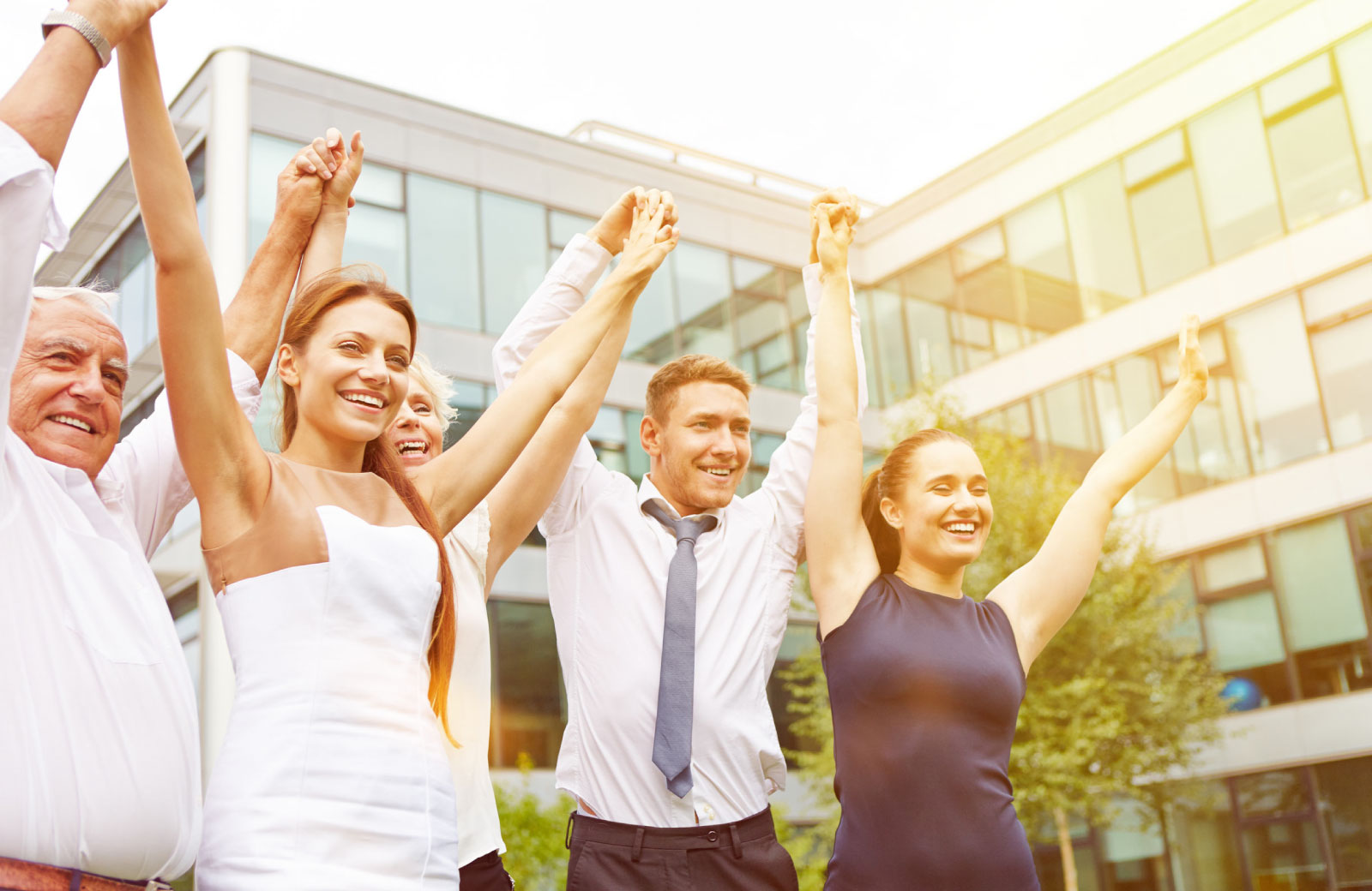 employees raising their hands together