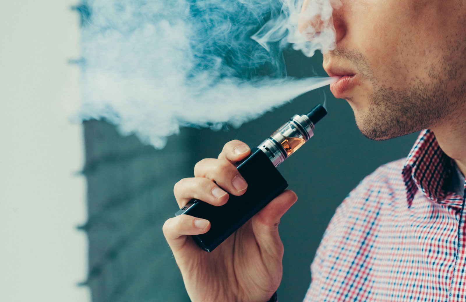 person blowing smoke from a vape