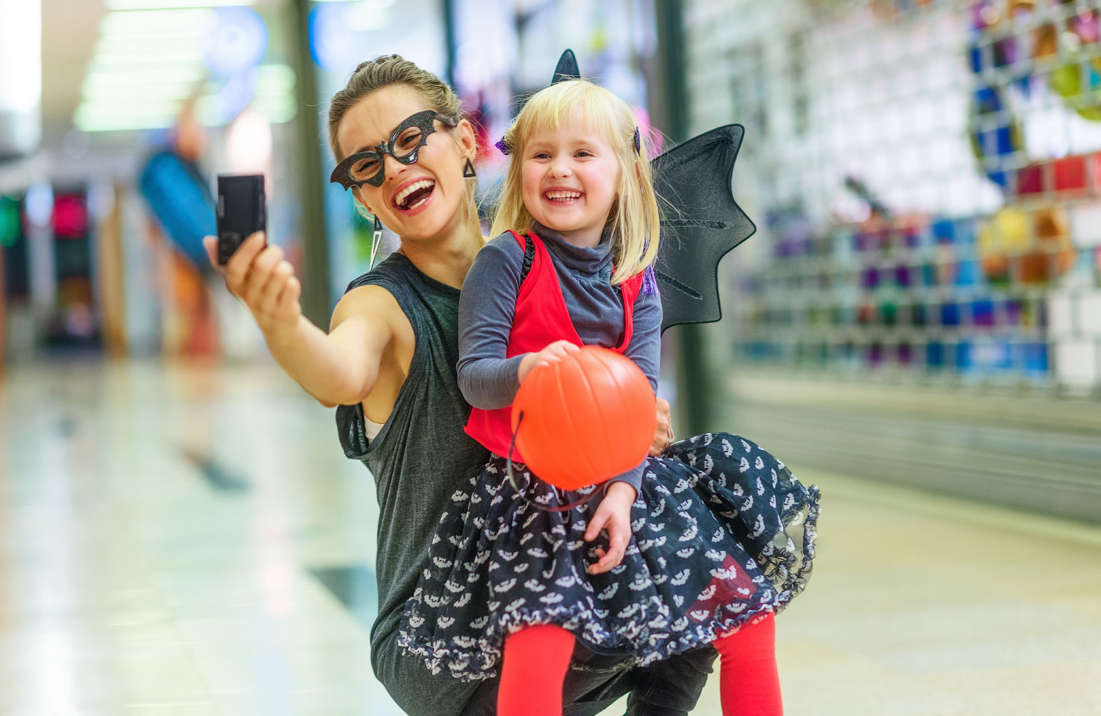 mother and daughter in halloween costumes taking a selfie