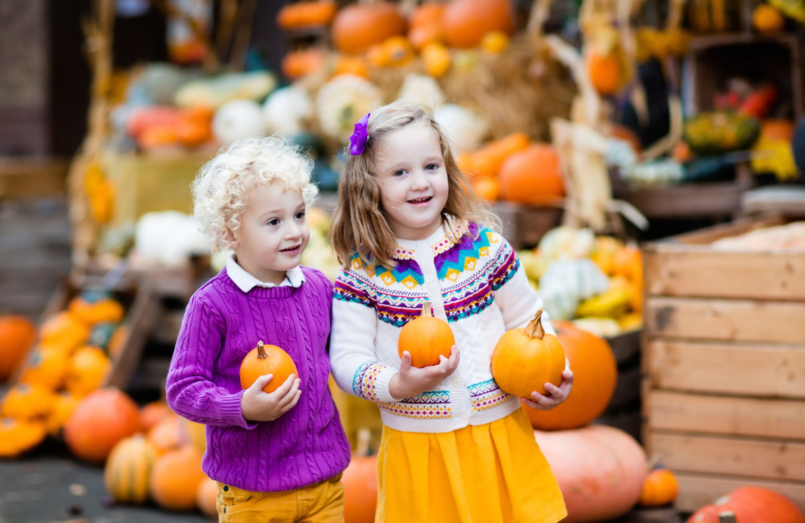 children holding pumpkins