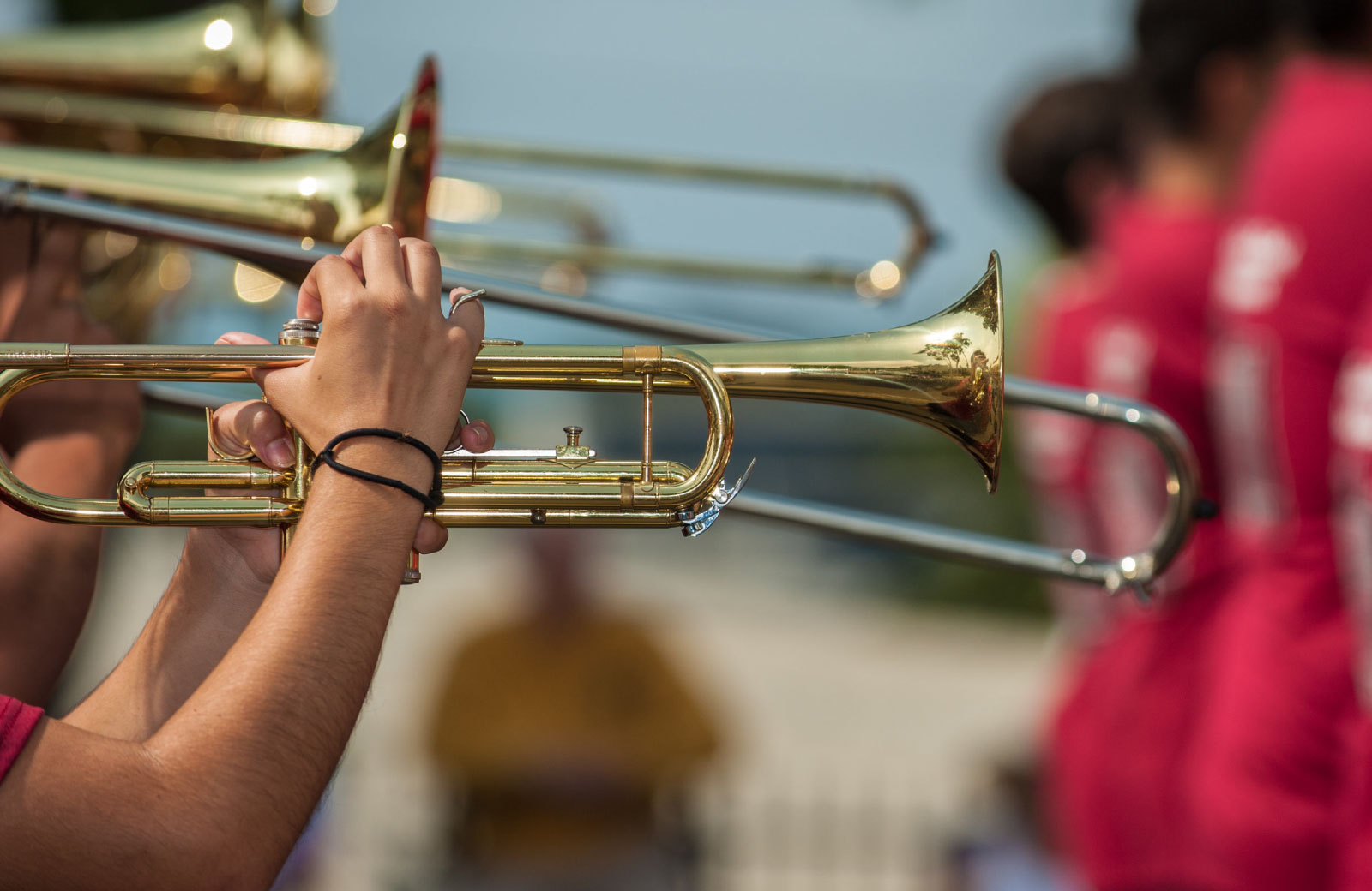 people playing trumpets in a marching band