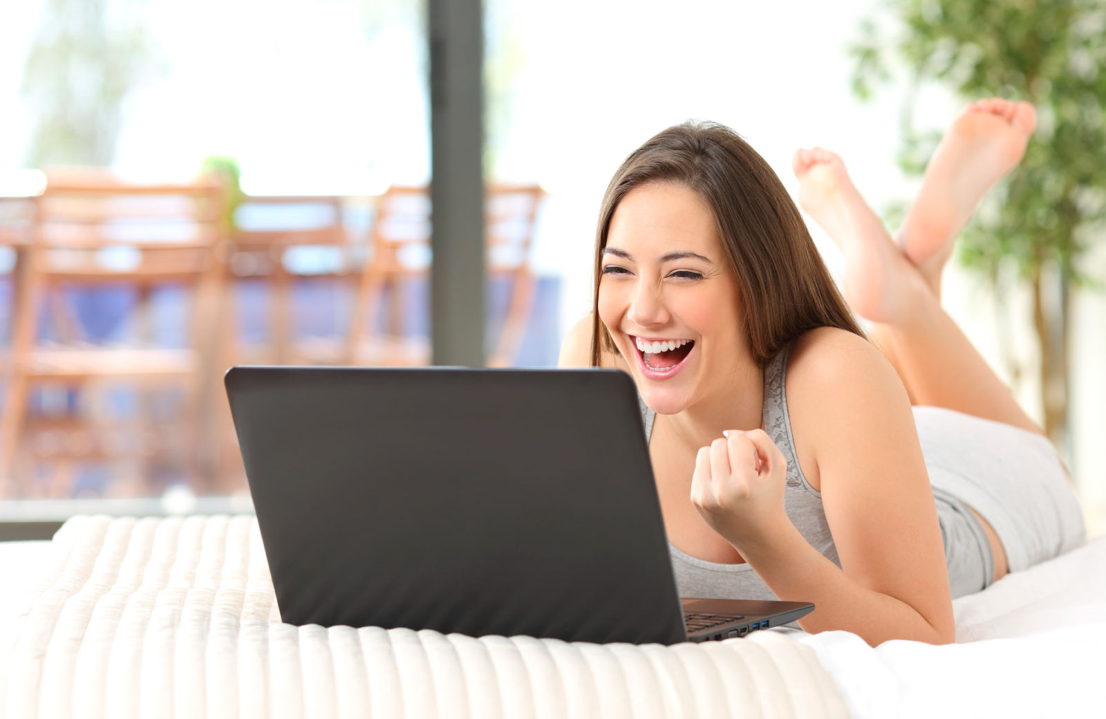 women really happy looking at her laptop
