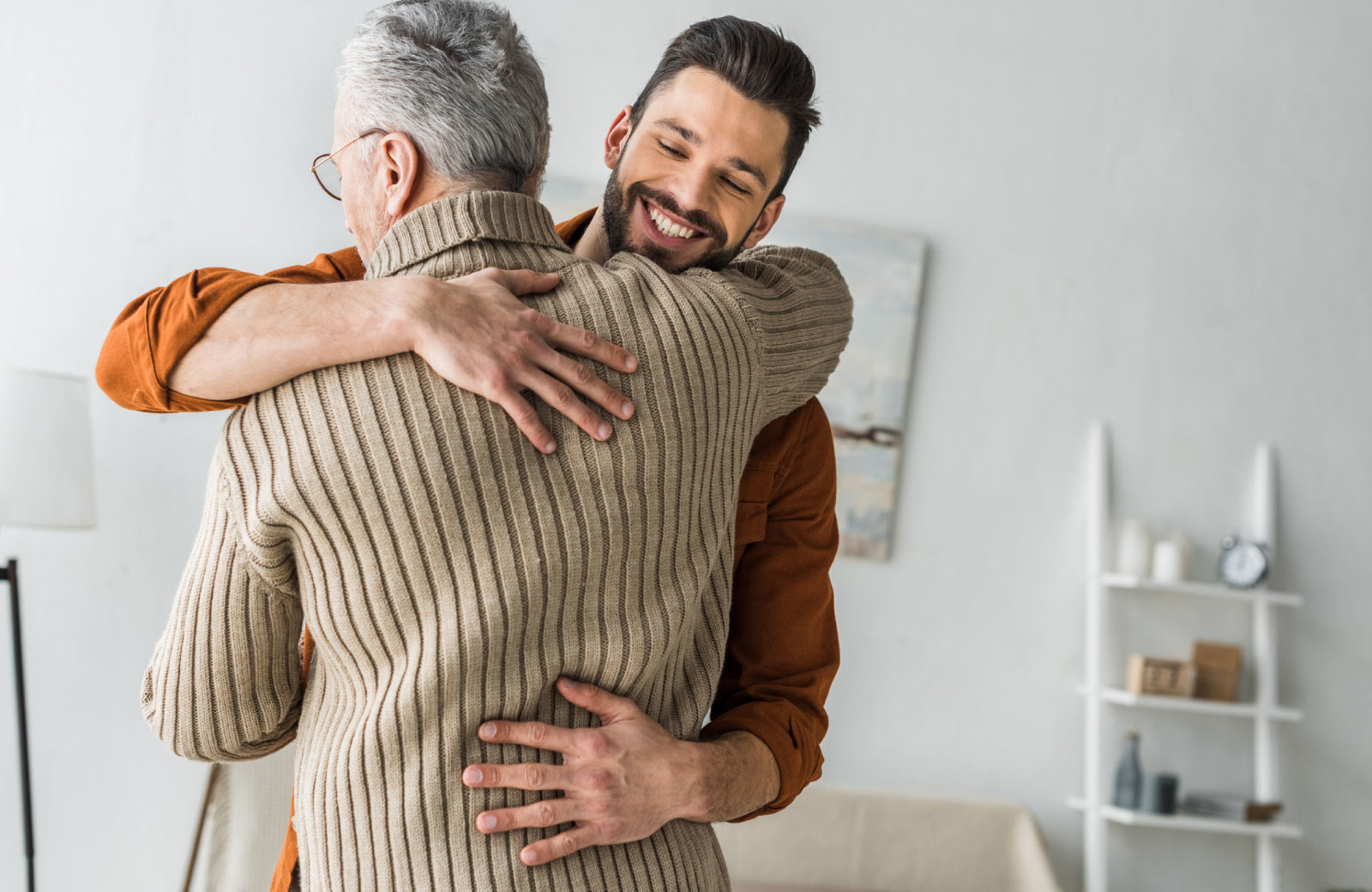 man embracing an older man