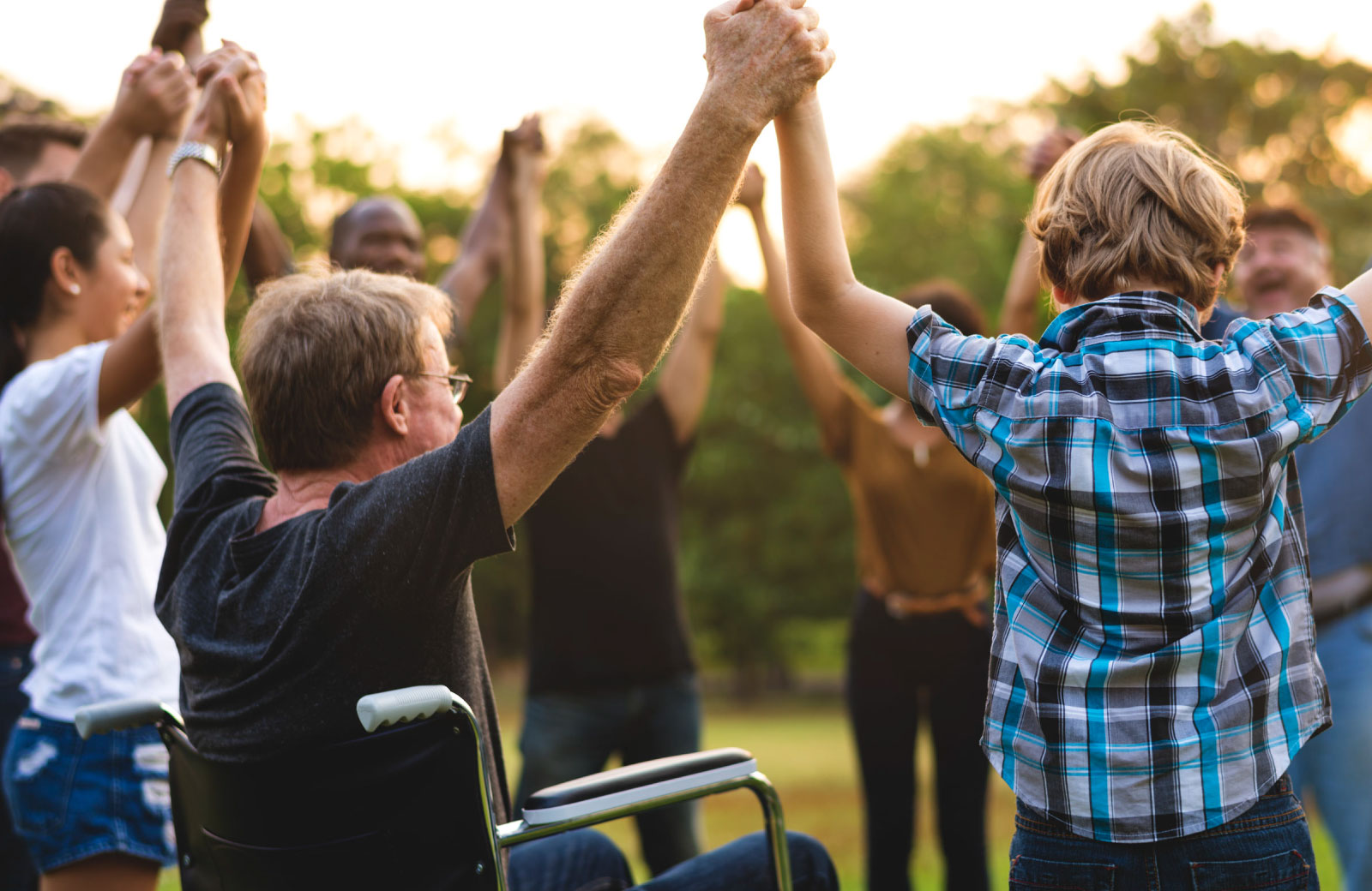 group of people holding and raising hands