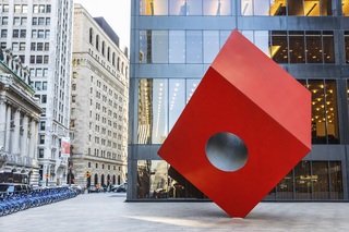 Isamu Noguchi's Red Cube art sculpture outside a building in Manhattan.
