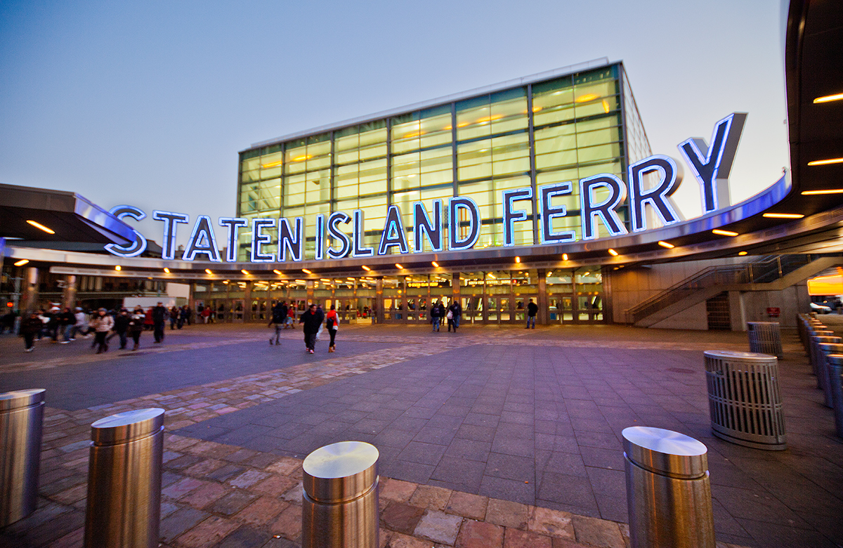 people walking into the Staten Island Ferry terminal at dusk - 15 Cliff neighborhood