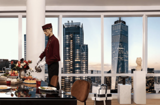 A concierge at an apartment building pours tea in a luxurious apartment setting with floor-to-ceiling windows facing views of Manhattan.