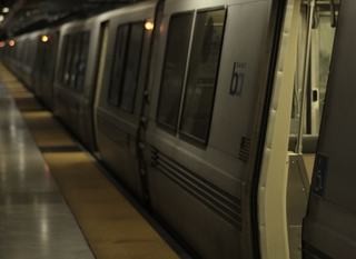 BART train stopped at an underground station platform in Downtown Oakland
