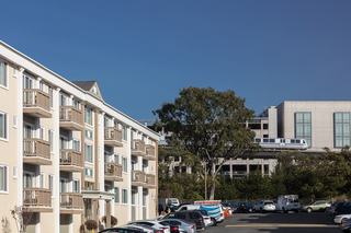 BART train going by near Westlake Apartments in Daly City