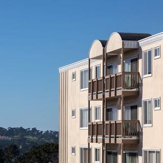 
Rear view of Poncetta apartment building exterior with wooden balconies