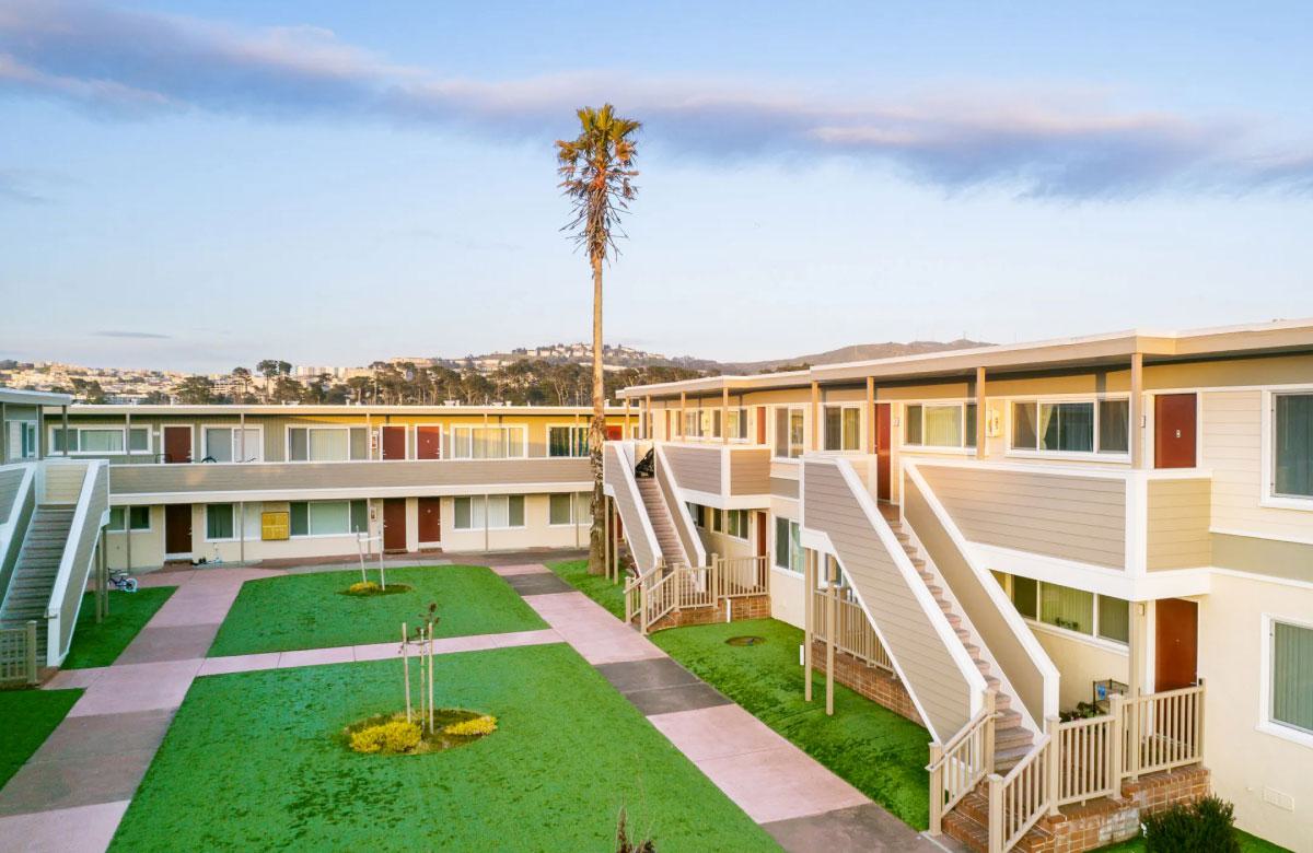 Plaza West - two-story apartments and townhomes with exterior entry and grassy courtyards with landscaping