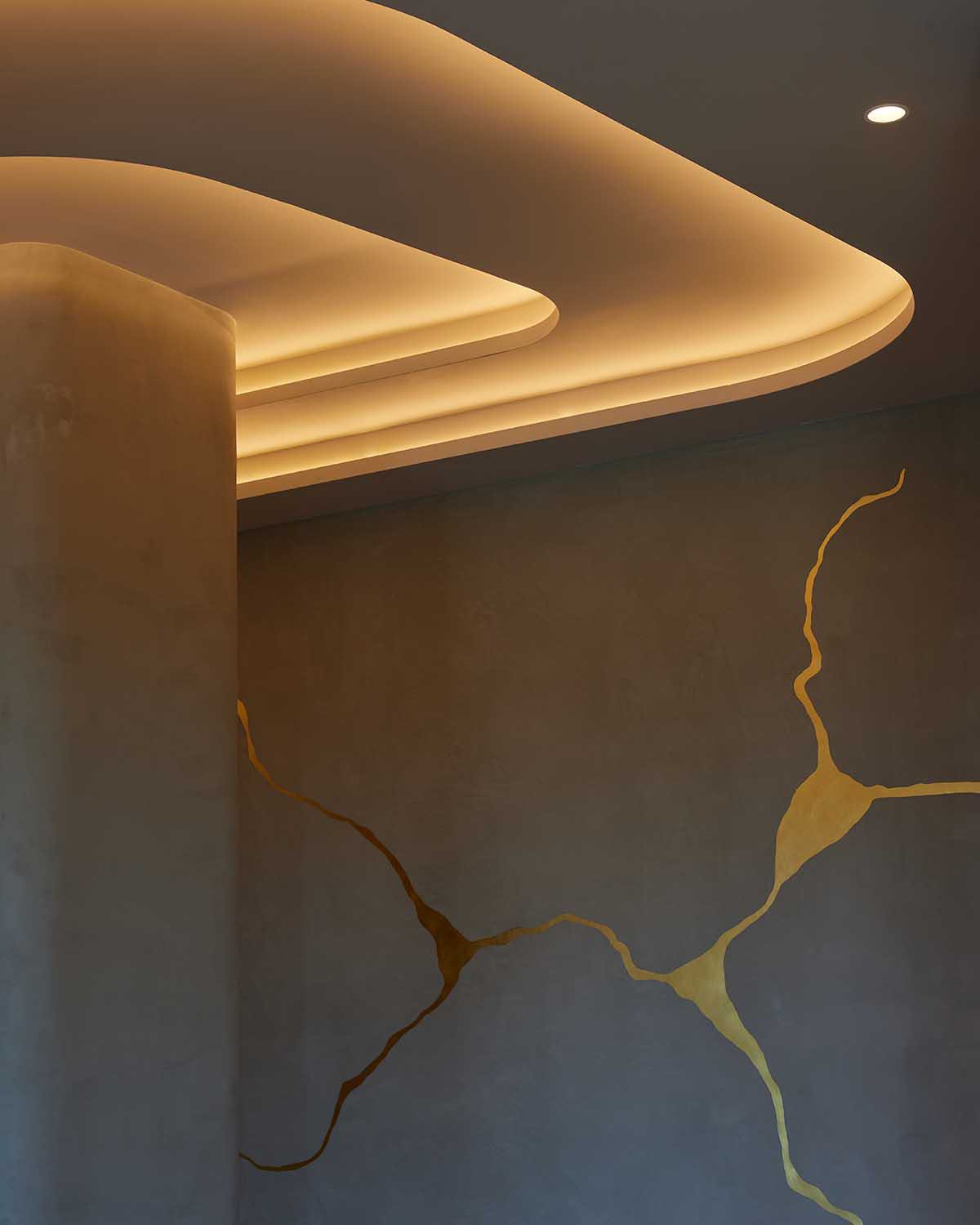 woman in a dress in an elevator pressing a button