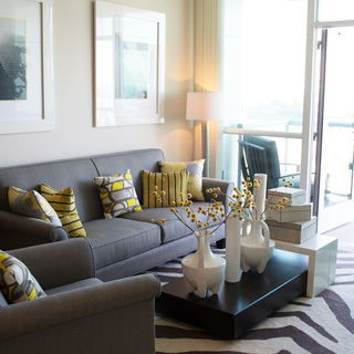 The Vue Apartment interior image of a modern grey sofa and chair - view Floorplans