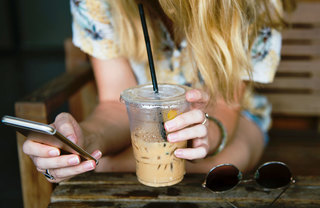 Girl with iced Coffee and Phone - Sol at West Village neighborhood - UC Davis
