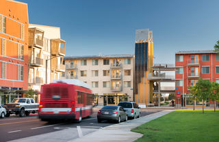 exterior view of Sol at West Village - Street with Buses