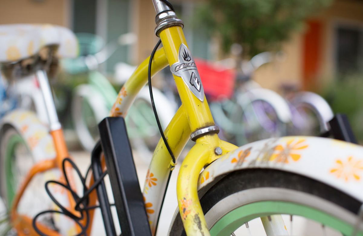 yellow bicycle parked in a bike rack with lots of other bikes - Bicycle Parking for Sol at West Village