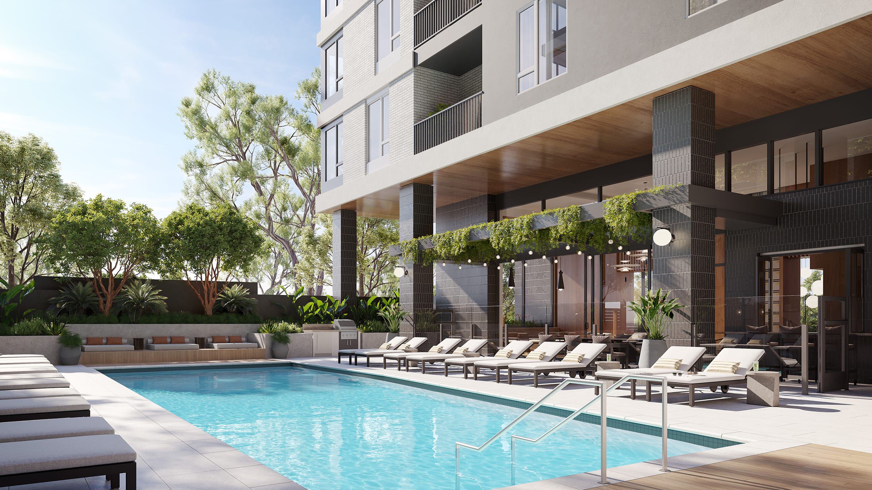 A sunlit outdoor pool deck with modern loungers, string lights, and lush greenery climbing over a shaded pergola. The clean-lined architecture and warm wood accents create a resort-style retreat nestled beside a contemporary residential building.
