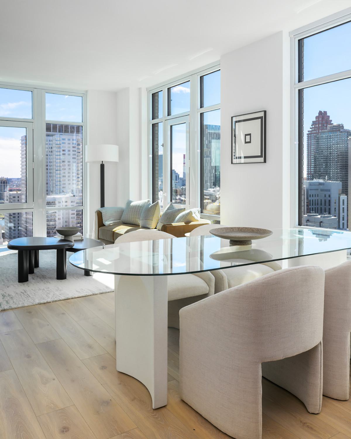 apartment living and dining area with high ceilings, great views, floor-to-ceiling windows, and elevated modern design