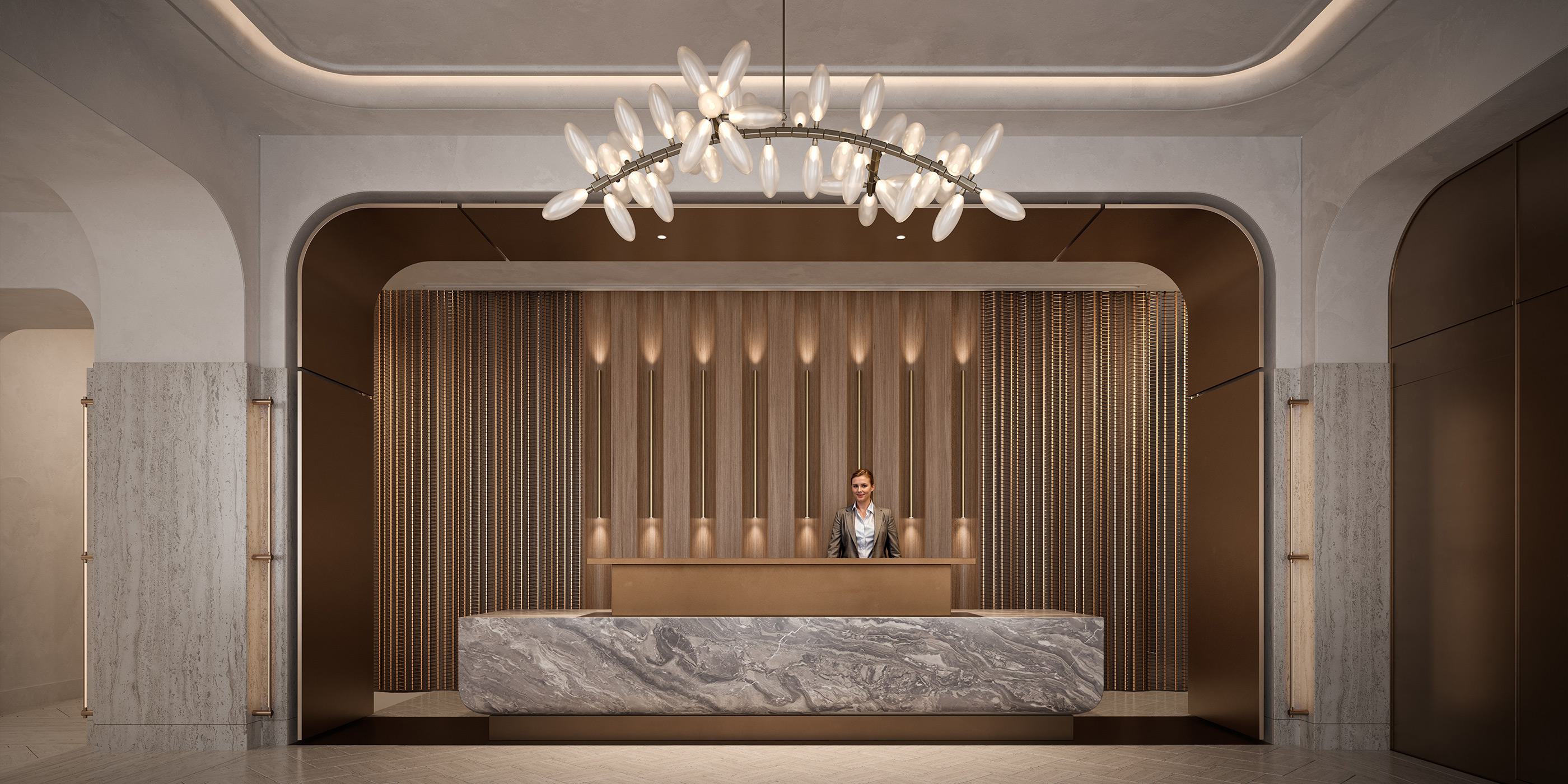 Elegant concierge lobby with a curved marble reception desk, warm wood and brass accents, and a sculptural chandelier resembling clustered glass petals. A concierge stands behind the desk in a sophisticated, modern interior.
