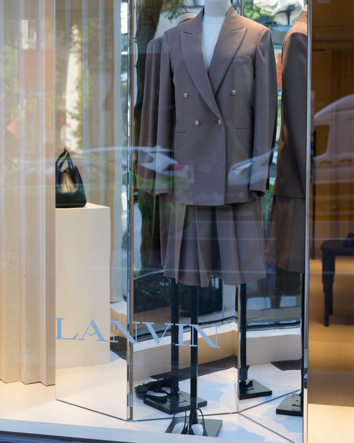 lanvin designer store window with elegant gray suit on display