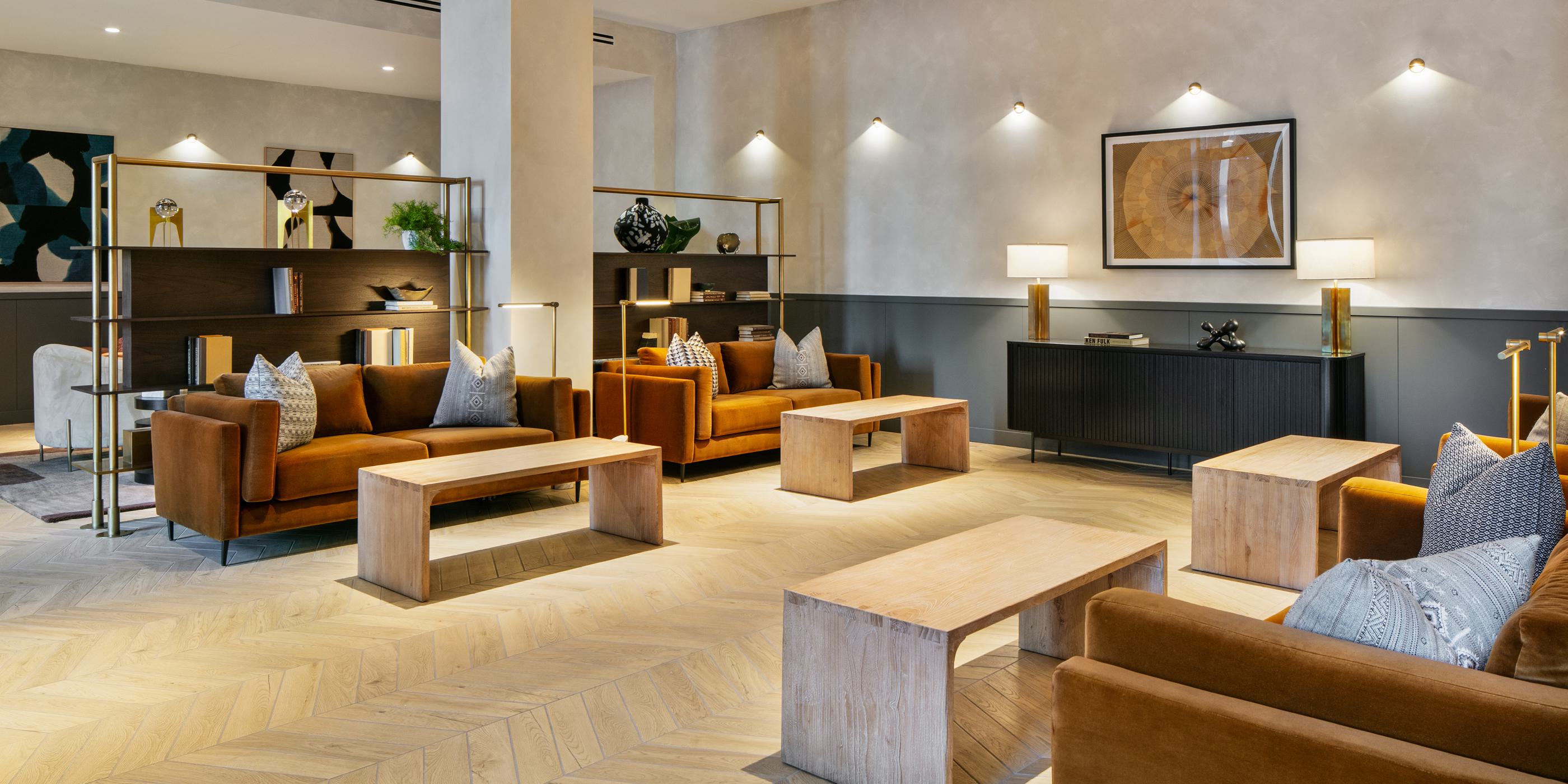 garden room at loden with huge floor to ceiling windows, superb natural light, lush views of flowering trees and plants outside, and thoughtful interior decor with indoor plants and numerous seating options for relaxing and enjoying the space