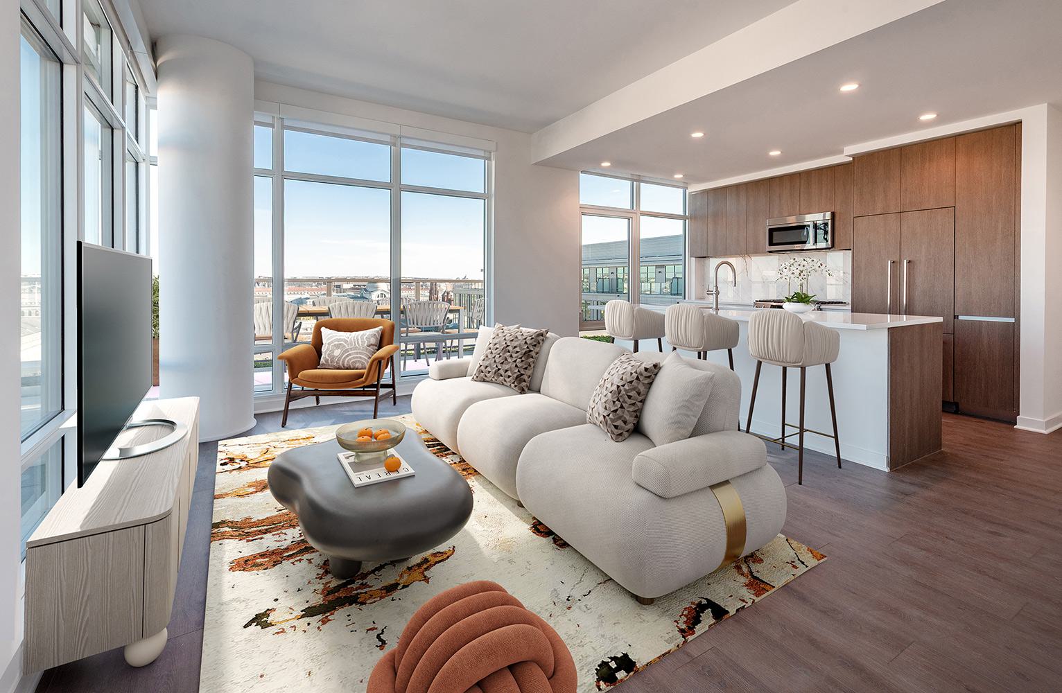 Modern open-concept apartment at The Collection at Annex on 12th, featuring a sleek kitchen with wood cabinetry, sculptural furniture, and floor-to-ceiling windows with views of Southwest DC
