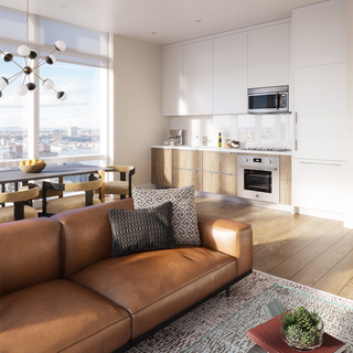 Interior of a 19 Dutch apartment with modern living room and dining room furniture and large windows and a kitchen in the background.