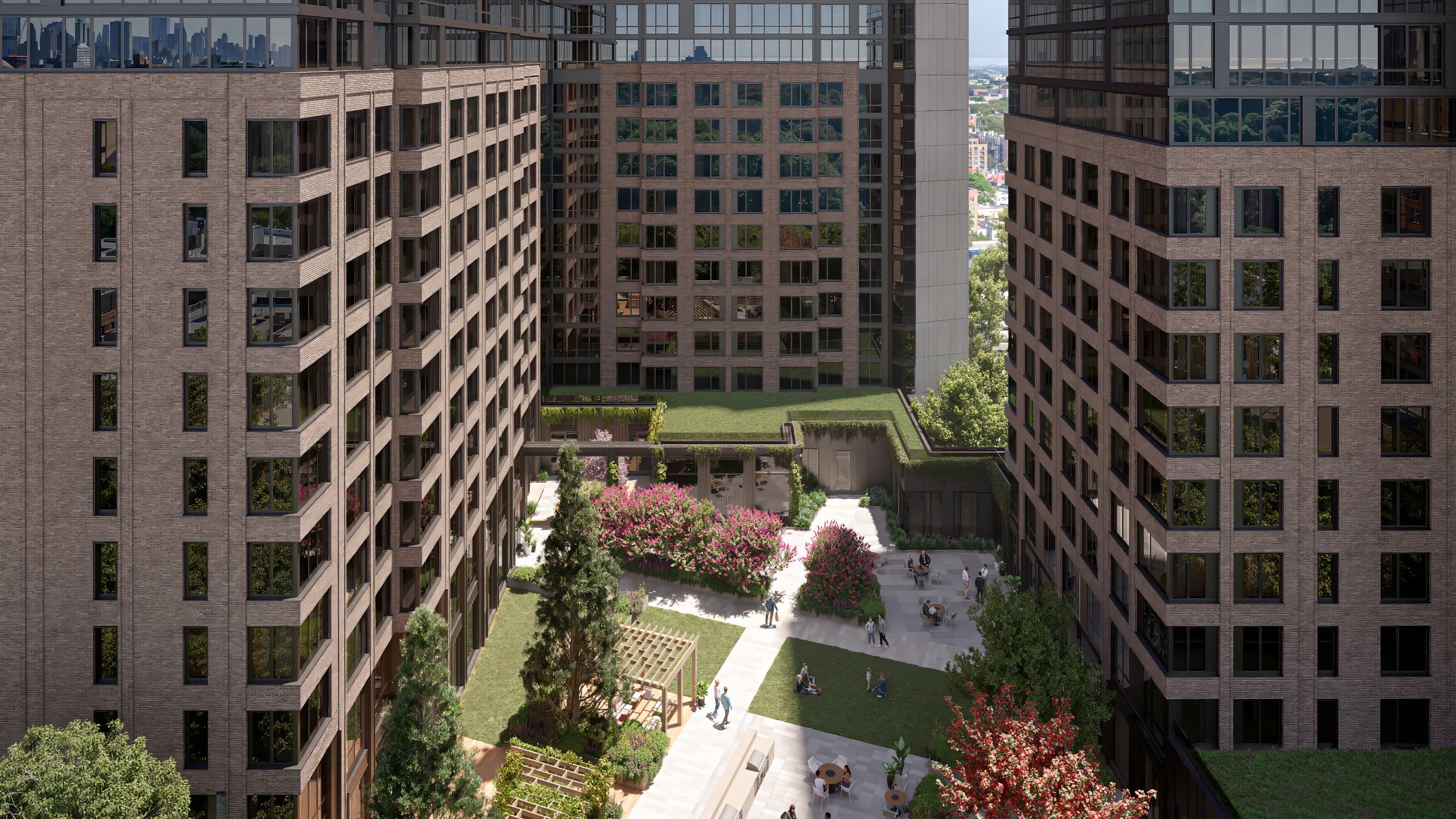 aerial view of a loden residential complex featuring two high-rise towers surrounding a landscaped courtyard with walking paths, greenery, and seating areas
