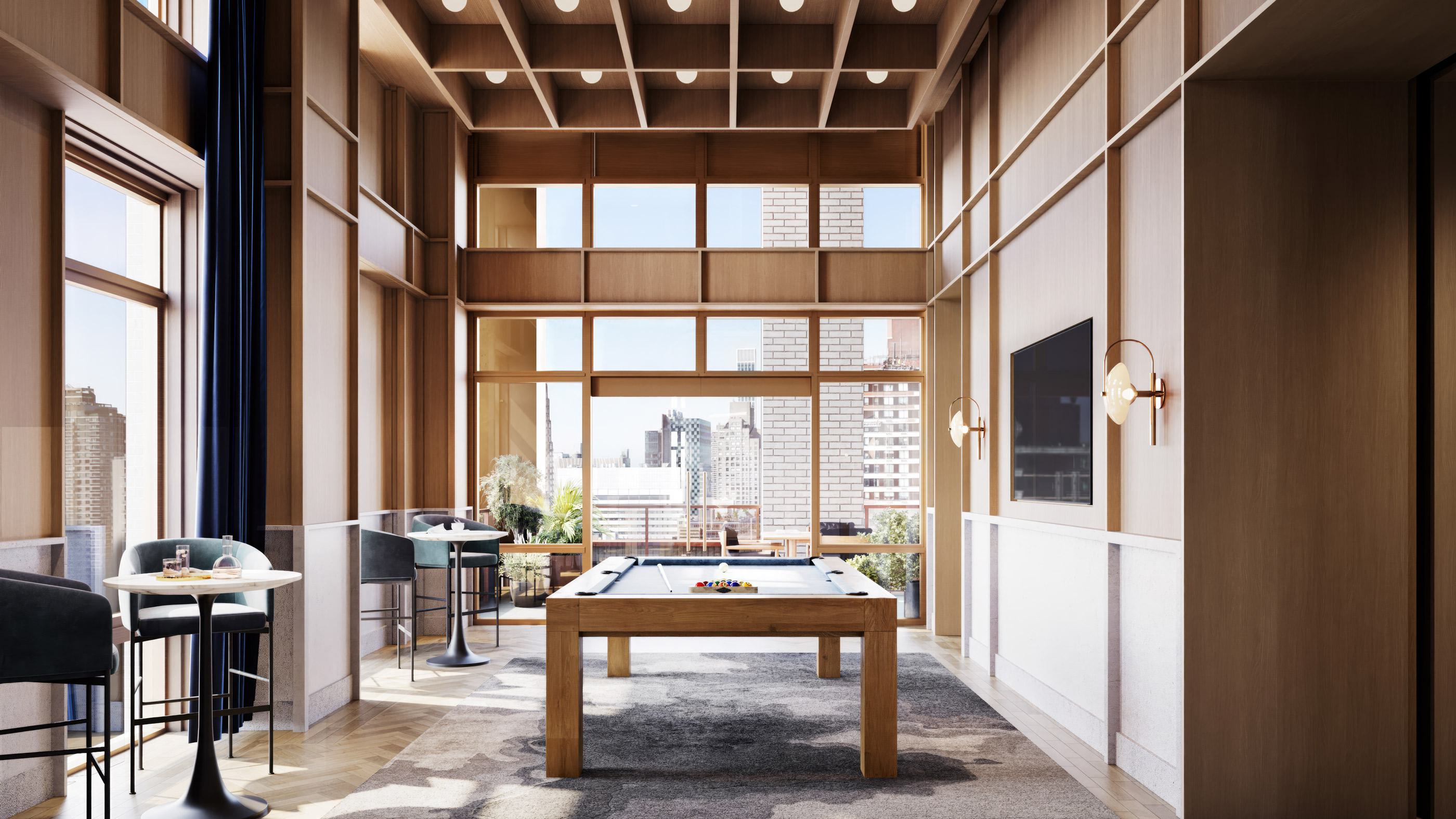 Elegant game room at Maison 78 featuring a central pool table, tall wood-paneled walls, floor-to-ceiling windows, and a coffered ceiling. A large TV is mounted on the wall, with café-style seating along the windowed perimeter and views of the Upper East Side skyline.
