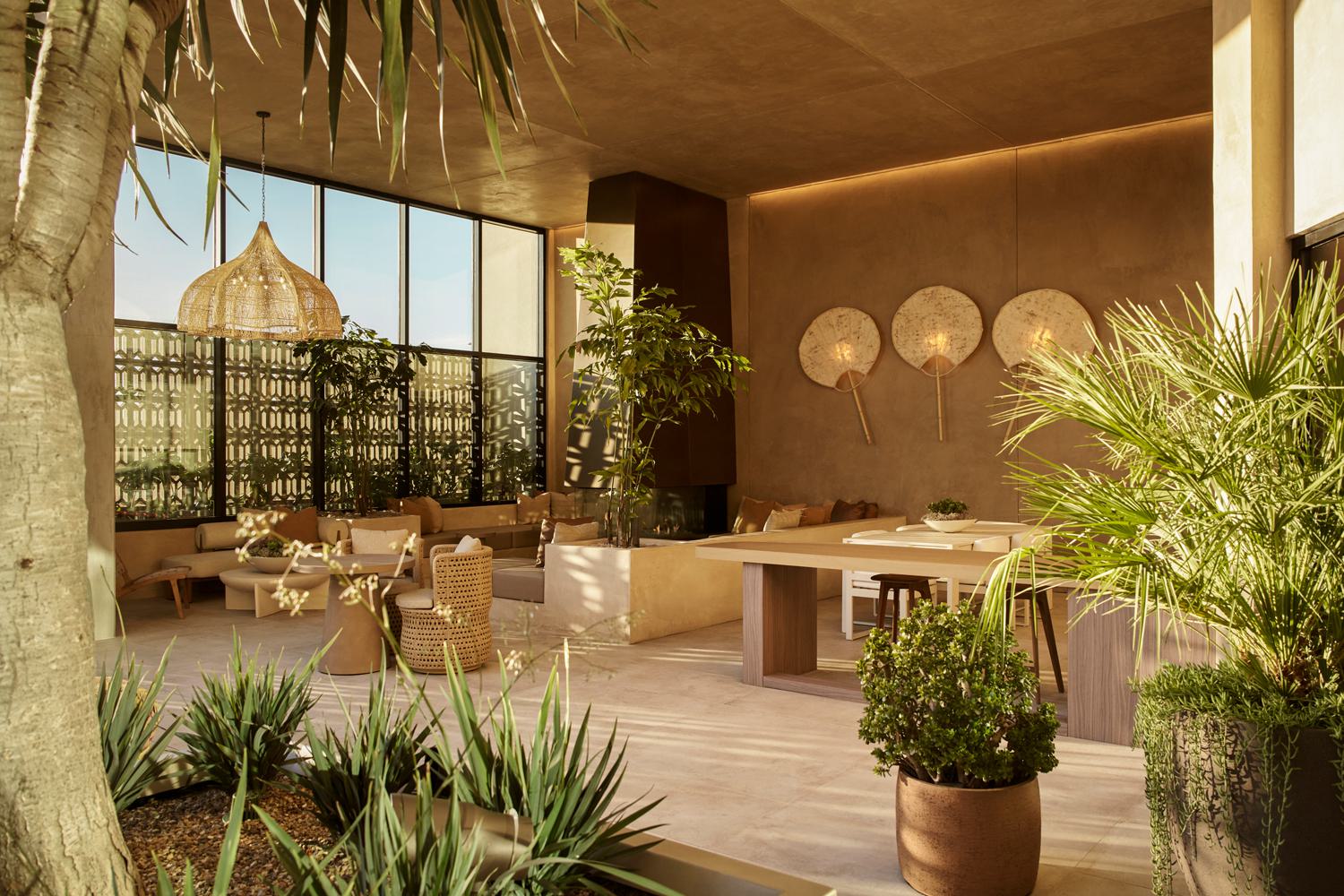 lounge featuring a tropical mural, plush seating, a billiards table, and warm wood accents, creating a relaxed yet sophisticated atmosphere.