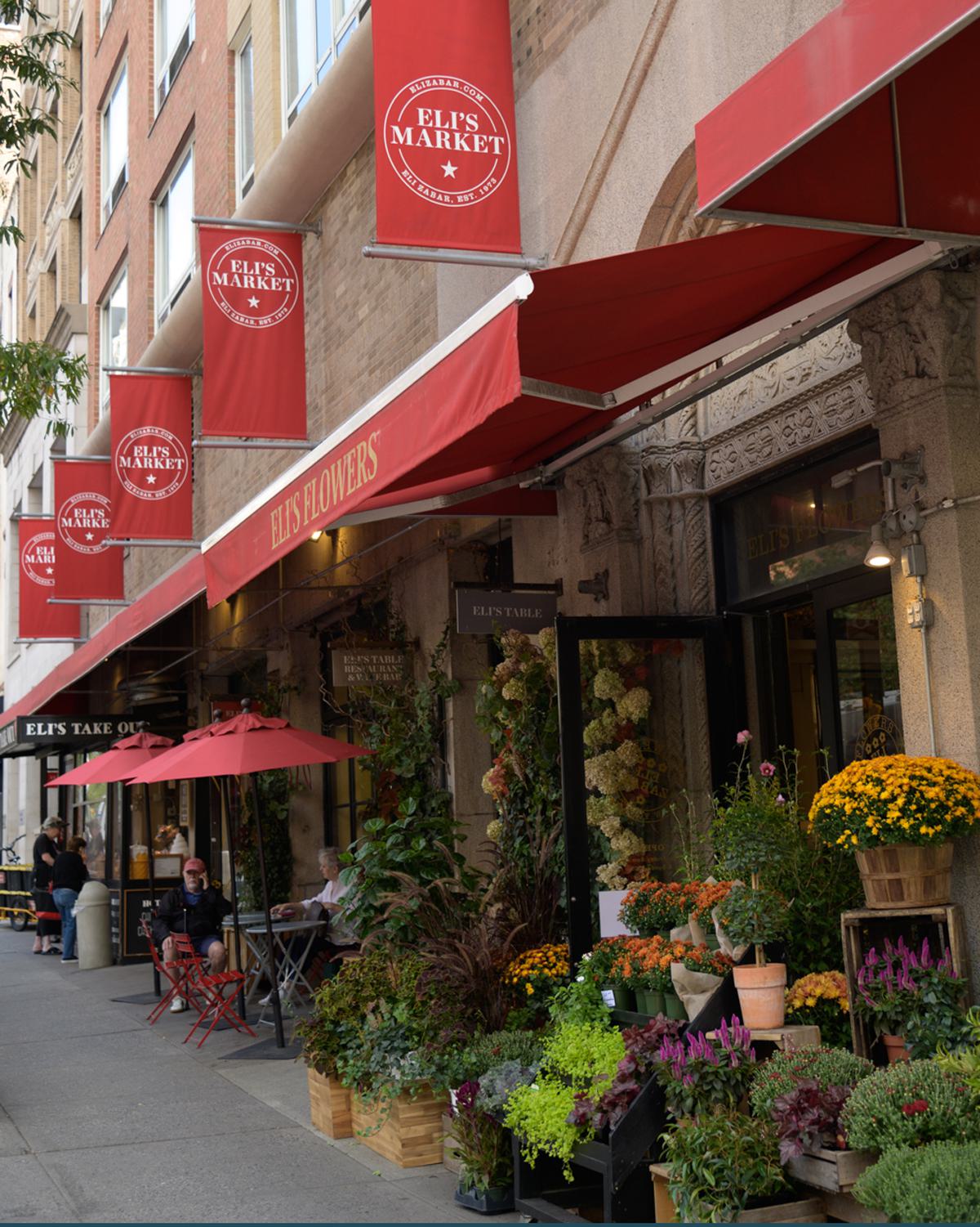 exterior of Eli's market in the UES with sidewalk display of colorful flower arrangements 