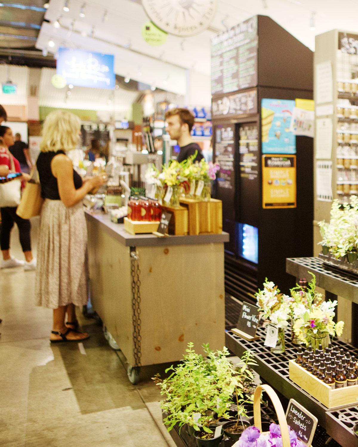 Boston Public Market, featuring a small vendor selling fresh herbs, flowers, and specialty goods