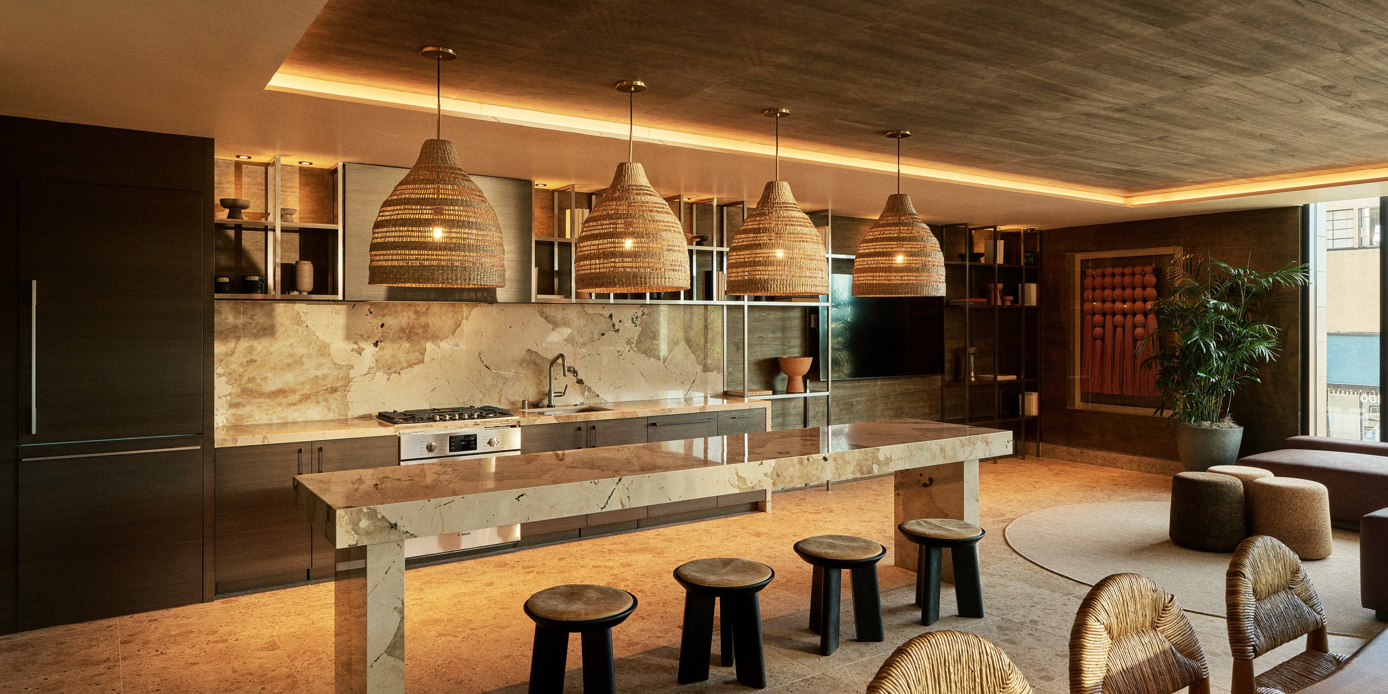 bright and modern apartment living room with floor-to-ceiling windows, a neutral-toned dining and seating area, and a warm, minimalist aesthetic overlooking San Diego skyline.