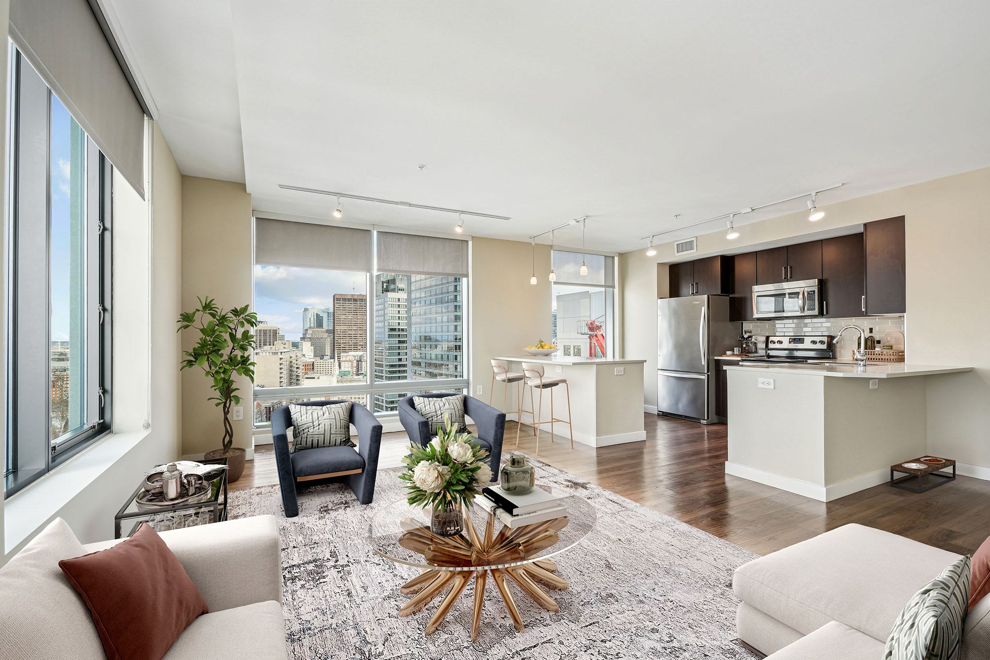 modern living room at Luka with floor-to-ceiling windows and downtown Boston views