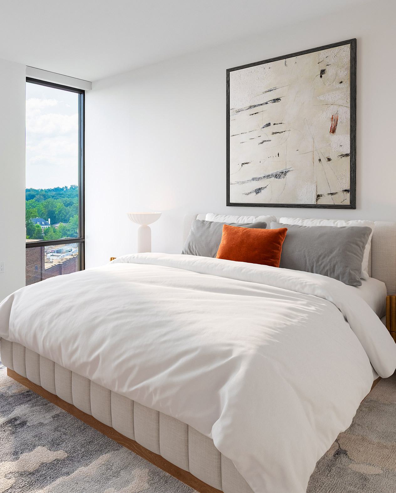 modern bedroom with soft gray walls, floor-to-ceiling windows, and warm wood furnishings, offering a DC cityscape view beyond the glass