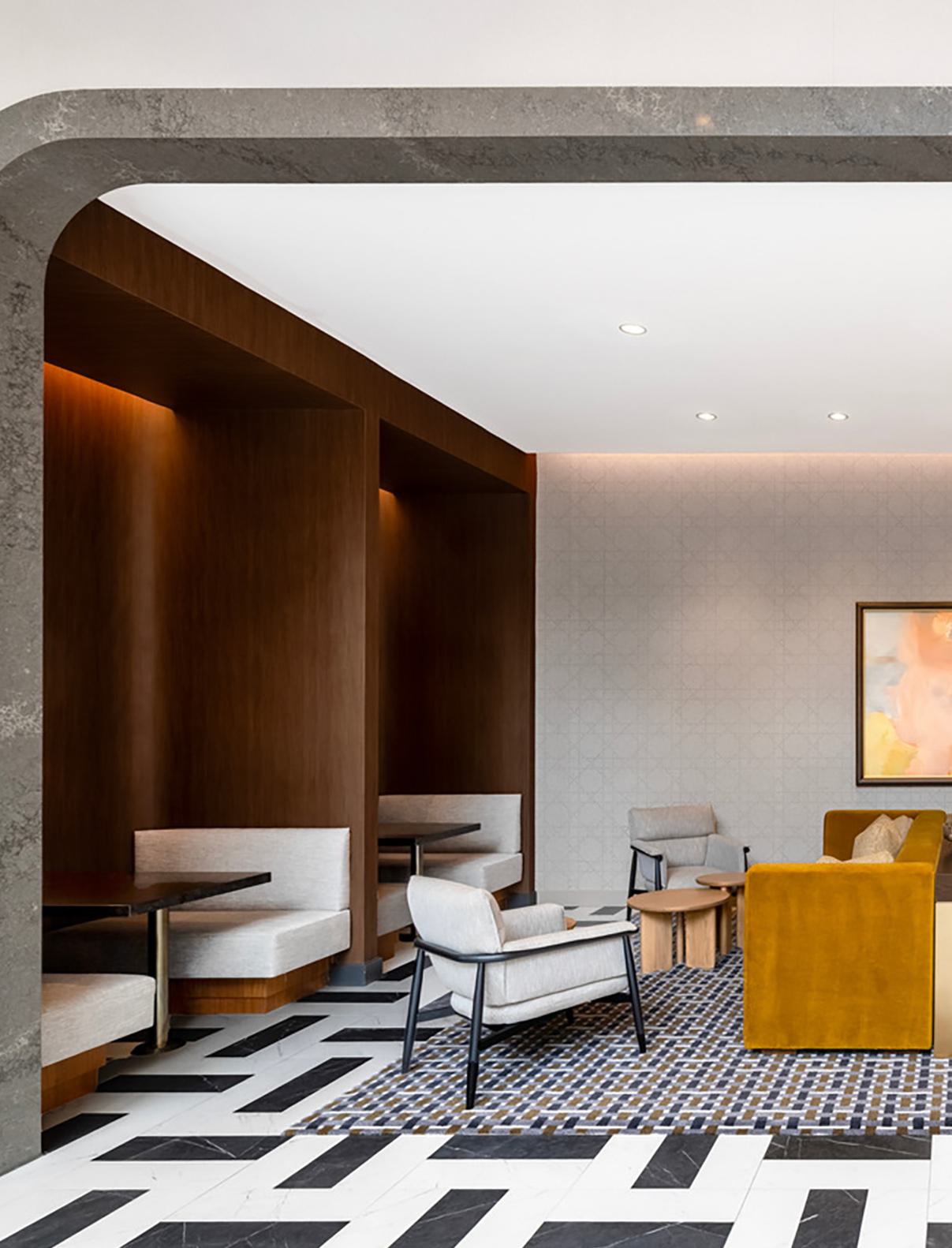 Sophisticated coworking lounge at Zephyr in Woodley Park, DC, featuring floor-to-ceiling windows that bring in natural light and views of the landscaped surroundings.