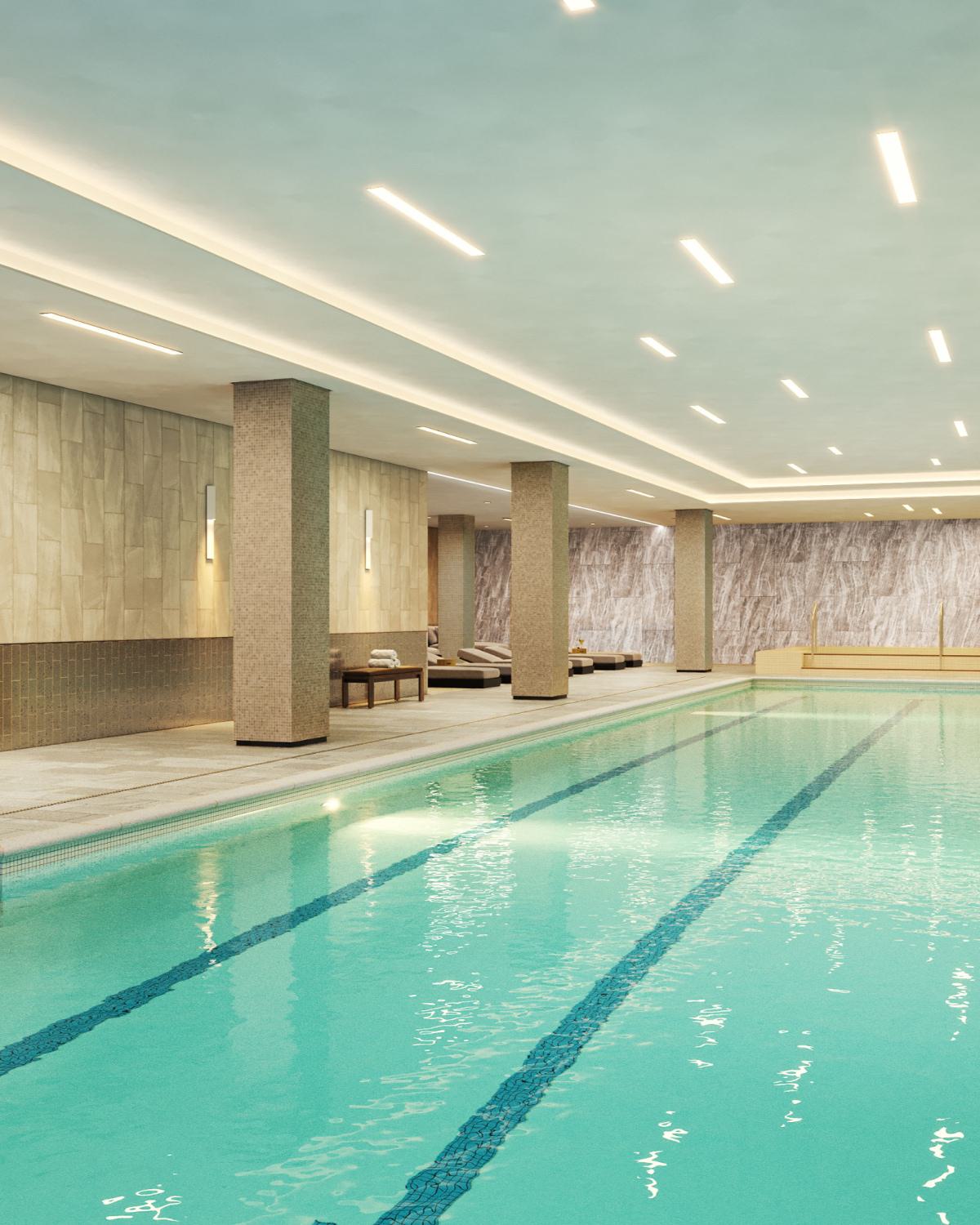 Indoor lap pool at Zephyr in Woodley Park, DC, featuring a serene, spa-inspired design with soft ambient lighting, textured walls, and poolside lounge seating along the perimeter.