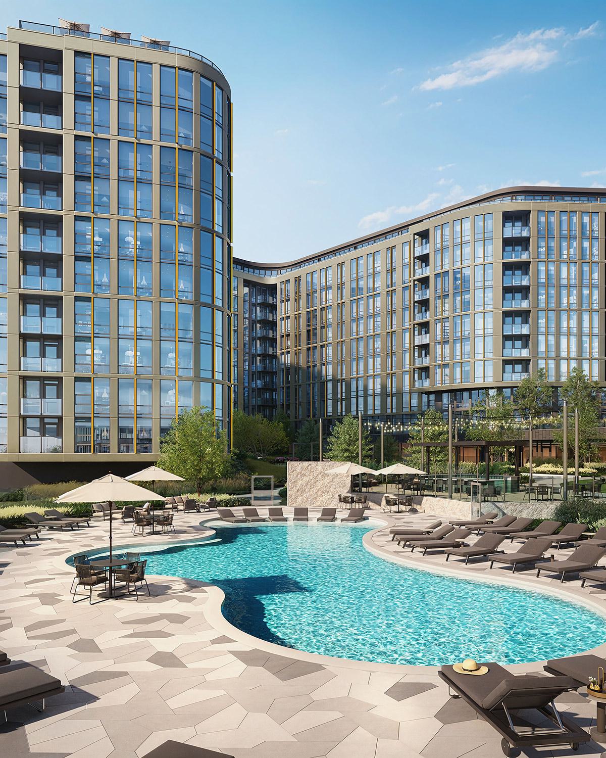 Resort-style pool at Zephyr in Woodley Park, DC, surrounded by sleek lounge chairs, umbrellas, and landscaped greenery, with the modern glass-and-metal façade of the high-rise building in the background.