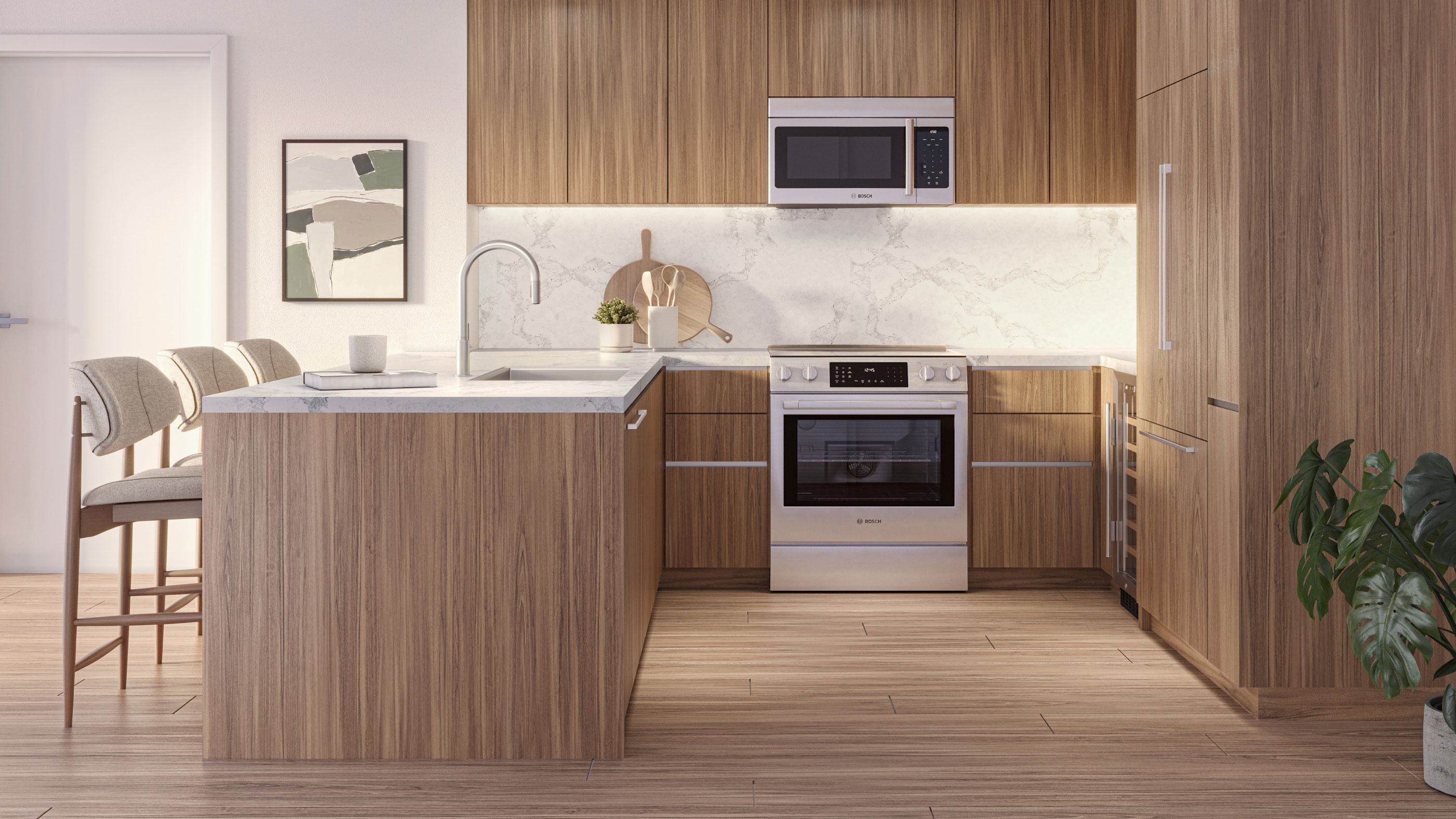 Collection residence kitchen at Zephyr in Woodley Park, DC, featuring upgraded Bosch stainless steel appliances, warm wood cabinetry, quartz countertops, and a sleek marble backsplash with a peninsula island and seating.