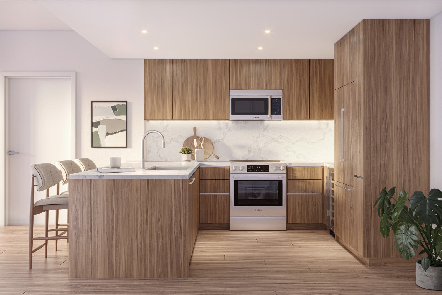 Collection residence kitchen at Zephyr in Woodley Park, DC, featuring upgraded Bosch stainless steel appliances, warm wood cabinetry, quartz countertops, and a sleek marble backsplash with a peninsula island and seating.