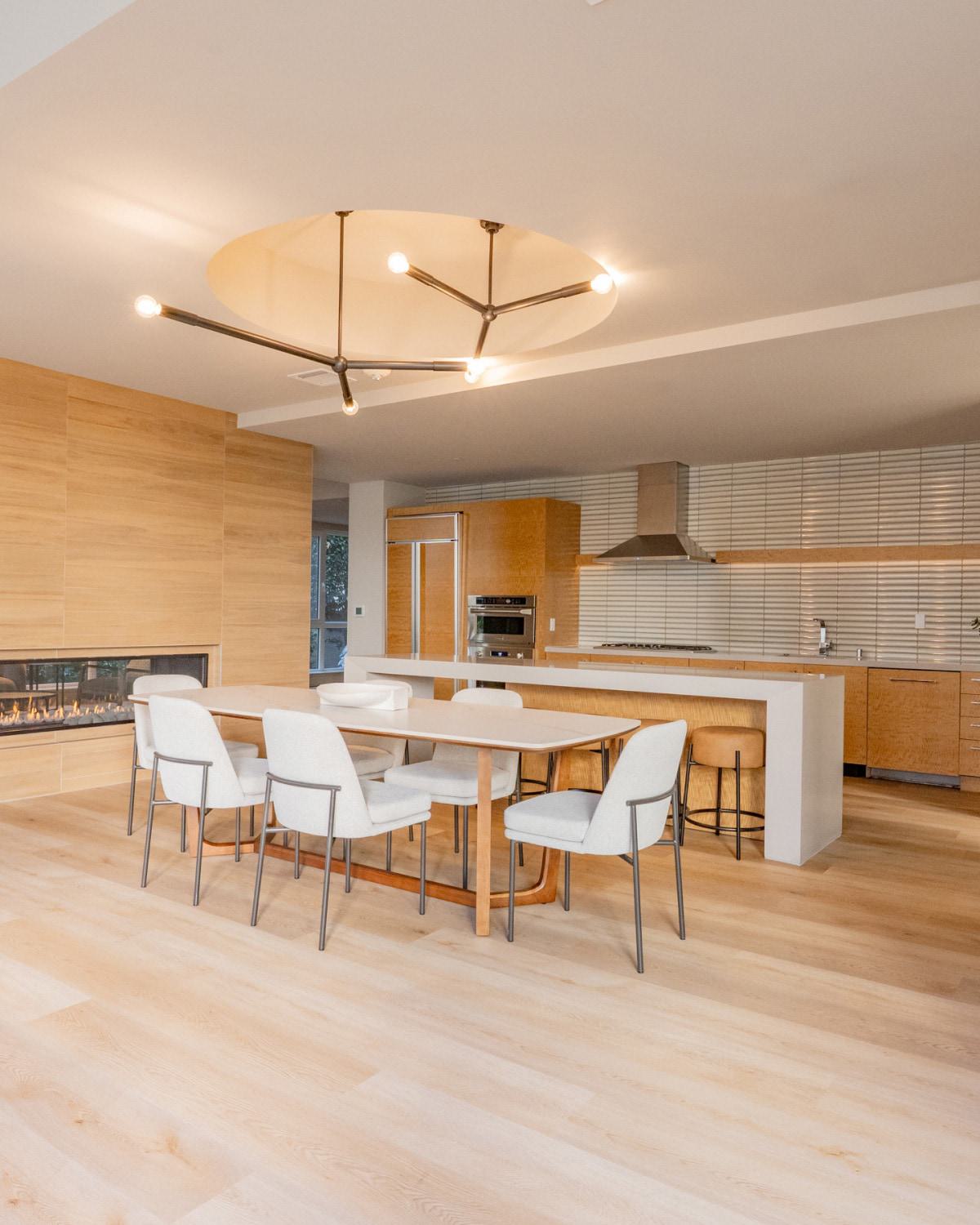 Modern community clubhouse at The Triton Apartments featuring a spacious lounge with contemporary seating, workstations, large windows for natural light, and stylish decor.