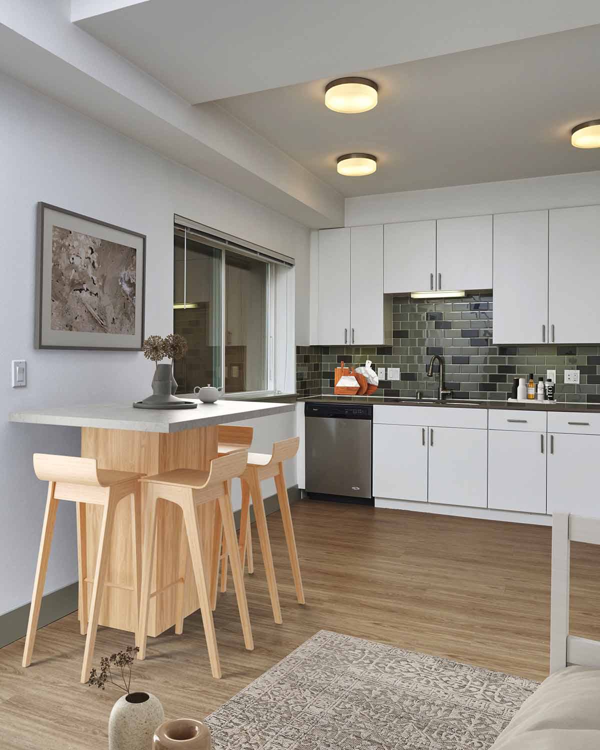 Contemporary kitchen with sleek white cabinetry, a dark tile backsplash, and a cozy dining island with wooden bar stools and warm wood flooring.